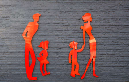 Red people silhouettes on brick wallの写真素材