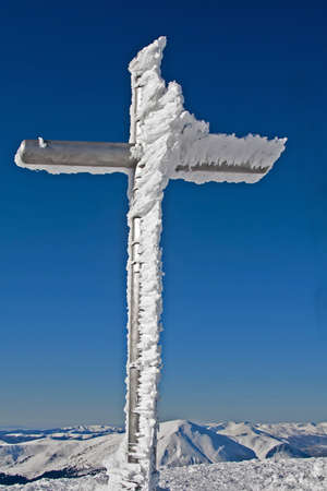 frozen cross on mountain summitの写真素材