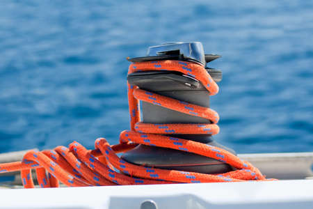 Winch with red rope on yacht in the seaの写真素材