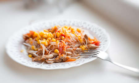 Pasta with turkey meat, tomato, carrot and corn, selective focusの写真素材