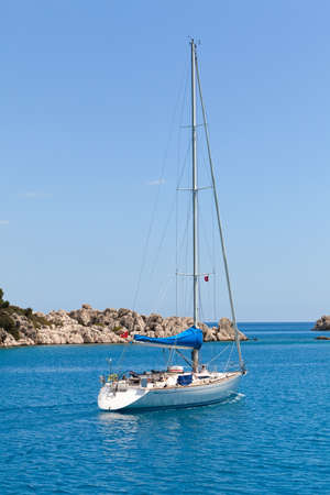 White sailboat in turkish bay on blue sea