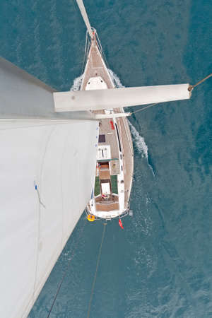 Top view of sailing boat with water splash
