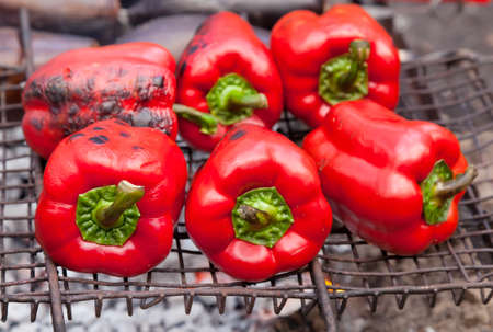 Red grilled pepper on bbq fireplaceの写真素材