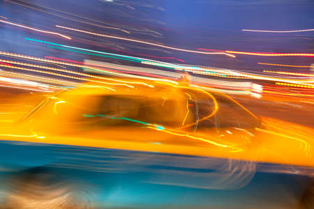 Taxi cab blured in motion on night city streetの写真素材