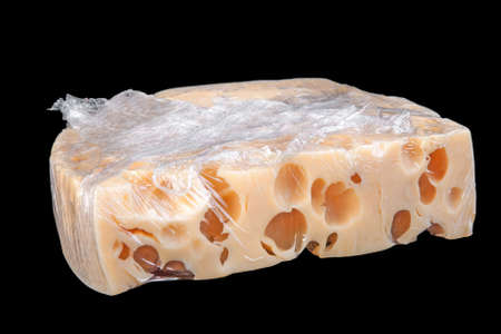 Packed cheese slice isolated on black backgroundの写真素材