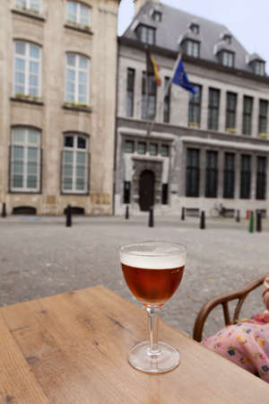 Glass of beer on table in street restaurant, Antwerpen, Belgiumの写真素材