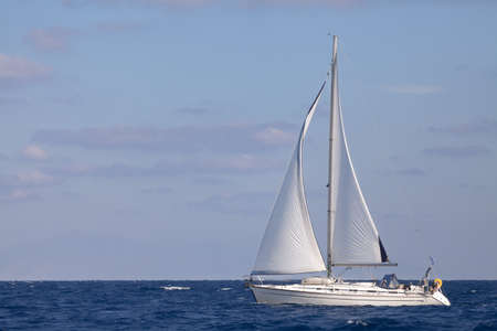 Sailing boat in open blue sea
