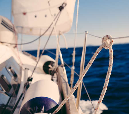 Knot on rope and sailboat crop in the sea