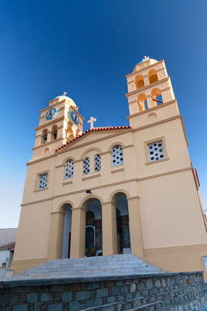 Yellow church and blue sky on the greek islandの写真素材