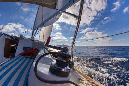 Winch with rope on sailing boat in the sea