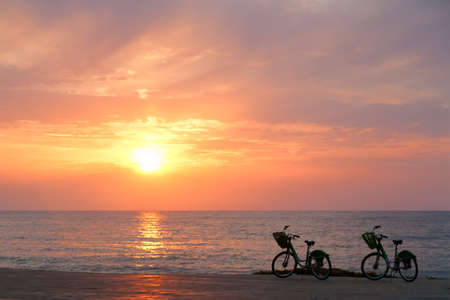 Two bicycles on Batumi beach, sunsetの写真素材