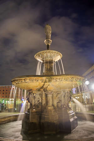 Lion statues fountain at night near Cologne cathedral, Germanyの写真素材