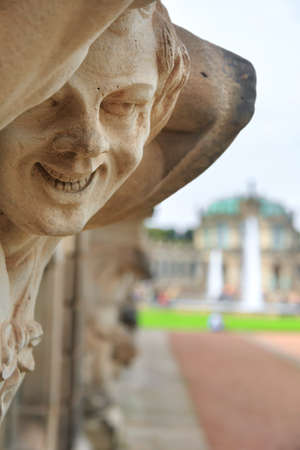 Closeup naked satyr smiling statue crop with fountain and garden at Zwinger palace in Dresden, Germanyのeditorial素材
