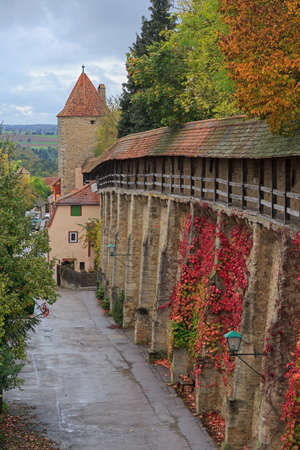 Rothenburg on Tauber castle wall and tower with autumn vines and treesのeditorial素材