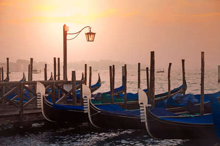 Venetian gondolas at sunrise in venice, Italyの写真素材