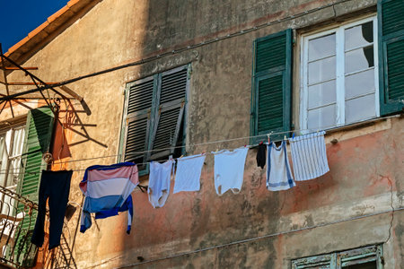 Vintage house facade with clothes hanging on ropeの写真素材