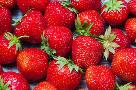 Fresh strawberries scattered on wooden table close-upの写真素材