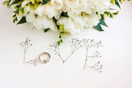 The word "Love" made up of flowers on a white background. Bouquet of flowersの写真素材