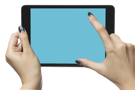 Happy young woman using digital tablet. Happy young student with eyeglasses is watching a movie on tablet. Female student is studying on a tablet at home.の写真素材
