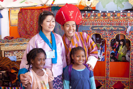 International Folk Art Market held annually in Santa Fe, New Mexico,  USA, woman and man from Tibet with tourist youngstersのeditorial素材