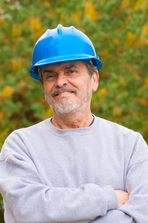 Contractor Builder with blue hardhat smiling