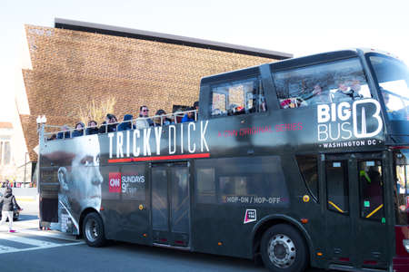 Washington, DC, USA â€“ April 1, 2019: Local metro bus with advertisement for Richard Nixon TV...