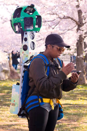 Washington DC â April 3, 2019: Google Street View camera operator at work during the cherry blossom festival in Washington DC. It's a technology featured in Google Maps and Google Earth that provides panoramic views from positions along streets in the wのeditorial素材