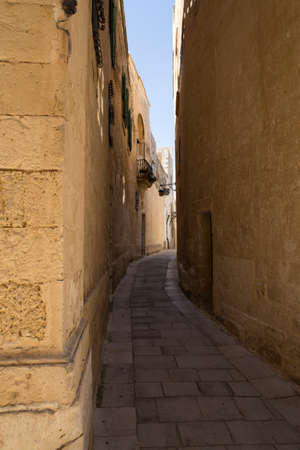 A narrow street in the historical medieval city of Mdina on Malta.の写真素材