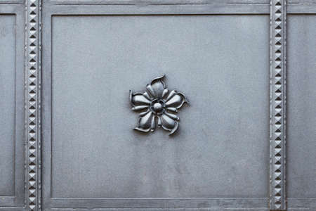 Beautifully crafted metal gate with an elegant flower in the middleの写真素材