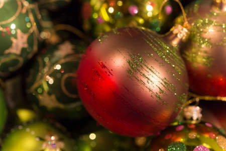 Beautiful red, pink and green christmas tree balls with green glitter decorationの写真素材