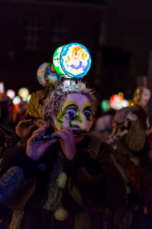 Basel carnival 2017. One carnival participant with an illuminated head lantern playing piccolo on monday morning in the streets. Picture taken on 6 of March 2017. Marktgasse in Basel Switzerland.のeditorial素材