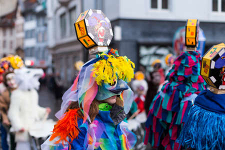 Basel carnival. Barfuesserplatz, Basel, Switzerland - March 6, 2017. Close-up of a single carnival participant with a bird like costume and mask during the Morgestraich parade. It rained a bit but this doesn't destroy the costumes and masks.のeditorial素材