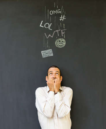 Single white adult man standing in front of a blackboard with drawn social media icons symbolizing...