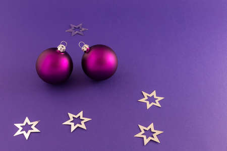 Beautiful purple christmas balls with satin effect and metallic silver stars on purple background.の写真素材