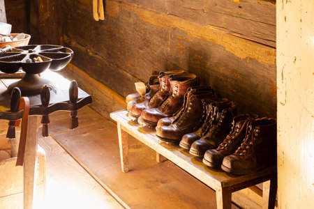 View into a small traditional shoemaker workshop with craft tools, equipment, materials and finished...