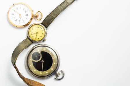 Set of watches on white background with a classic gold pocket watch a black and silver pocket watch...