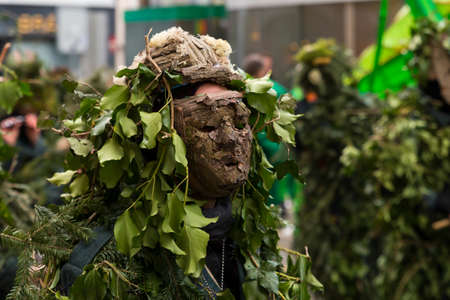 Basel carnival. Barfuesserplatz, Basel, Switzerland - February 21st, 2018. Close-up of a costume made of wood and leavesのeditorial素材