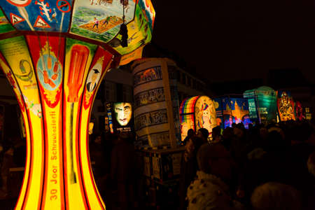 Muensterplatz, Basel, Switzerland - February 20th, 2018. Basel carnival. People watching the many illuminated carnival lanternsのeditorial素材