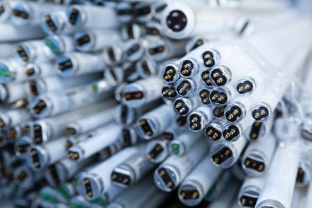Close-up of a stack of disused and discarded neon lamp tubes waiting for recyclingの写真素材