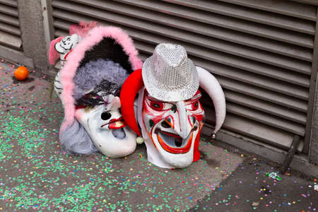 Baeumleingasse, Basel, Switzerland - March 12th, 2019. Close-up two carnival masks laying on the groundのeditorial素材