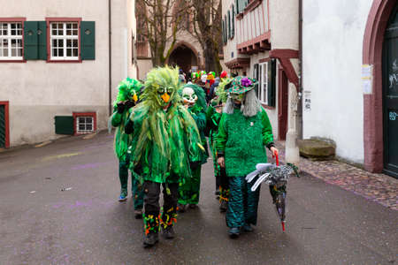 Heuberg, Basel, Switzerland - March 11th, 2019. Close-up of a carnival marching group in green...
