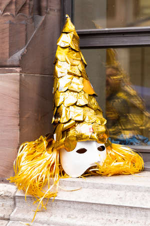 Ruedengasse, Basel, Switzerland - March 13th, 2019. Close-up of a beautiful golden carnival maskのeditorial素材