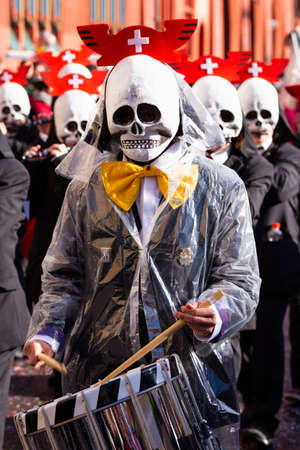 Marktplatz, Basel, Switzerland - March 13th, 2019. Portrait of a carnival snare drummer with a skull shaped maskのeditorial素材