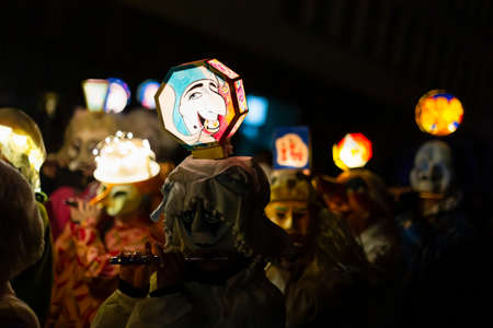 Marktgasse, Basel, Switzerland - March 11th, 2019. Close-up of piccolo players in their individual carnival costumes with illuminated head lanterns.のeditorial素材