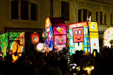Spalenberg, Basel, Switzerland - March 11th, 2019. Several illuminated carnival lanterns sticking out from the crowd in the old town.のeditorial素材