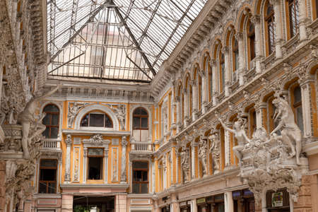 Ukraine, Odessa, Deribasivska Street, 12th of June 2019. The late 19th century shopping passage covered with a metal and glass canopy and decorated with stucco mouldings and sculptures.のeditorial素材