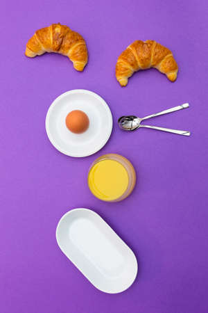 Fun breakfast concept with abstract happy smiling human face made of breakfast items on purple...