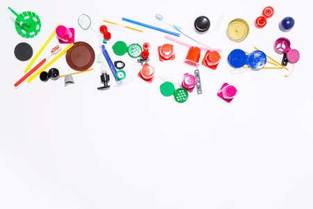 Assortment of obsolete plastic garbage items on white backgroundの写真素材