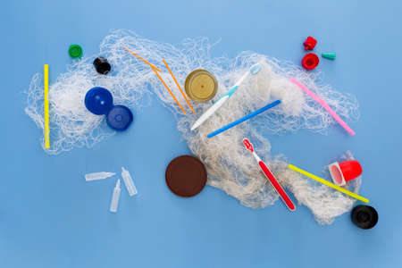 Assortment of obsolete plastic garbage items on colorful backgroundの写真素材