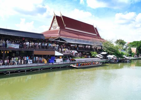 Many people in temple side river thailand のeditorial素材